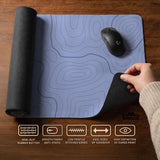 A periwinkle deskmat with thin blue contour lines printed across the surface.