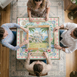 Pastel mahjong mat with a pink gingham border, seashells, hydrangea pots, palm trees, croquet details, and a coastal garden scene.