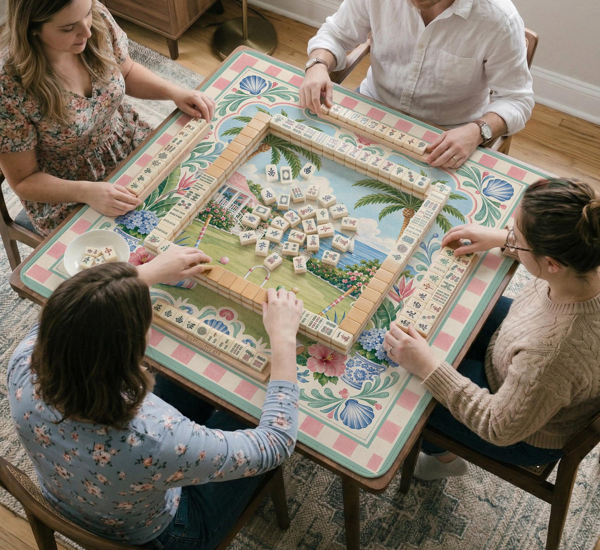 Pastel mahjong mat with a pink gingham border, seashells, hydrangea pots, palm trees, croquet details, and a coastal garden scene.