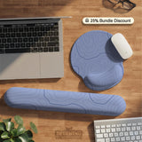 A periwinkle deskmat with thin blue contour lines printed across the surface.