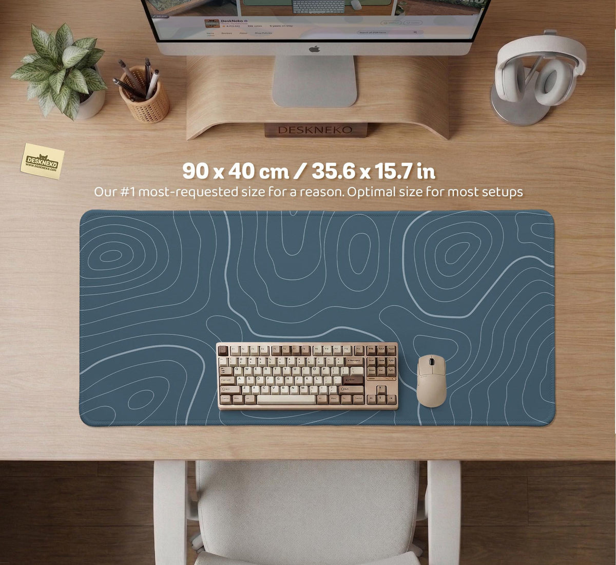 Blue mousepad with a topographic line pattern on a slate background.