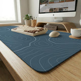 Blue mousepad with a topographic line pattern on a slate background.