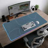 A slate blue desk mat with thin contour line map art on a light background.