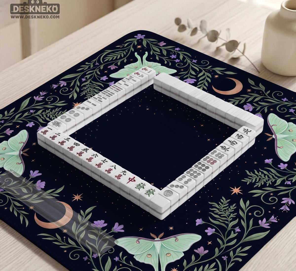 Navy square mahjong mat with a floral border, copper moons, scattered stars, pale moths, and leafy botanical details.