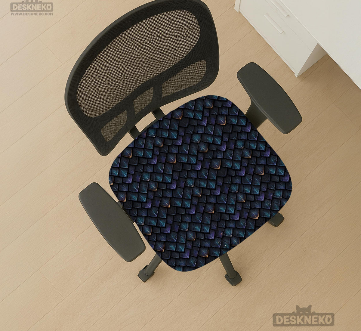 An indigo desk chair cover with a dragon scale pattern in blue, navy, purple, and copper tones, shown as a stretch slipcover with coverage options.