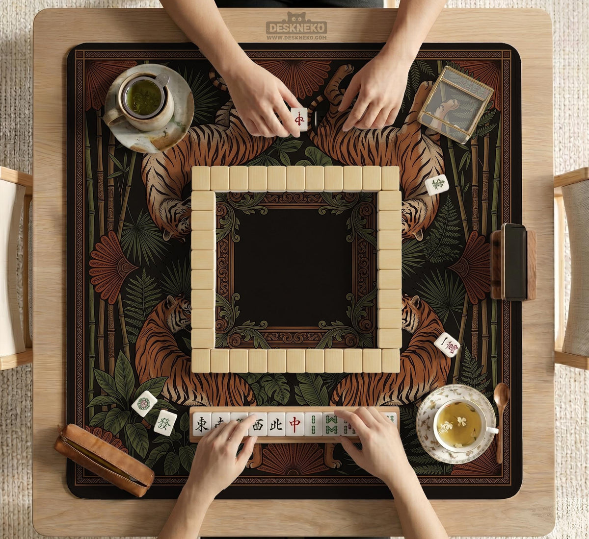 Black square mahjong mat with mirrored tiger faces, bamboo, dark tropical leaves, ornate border details, and orange accents.