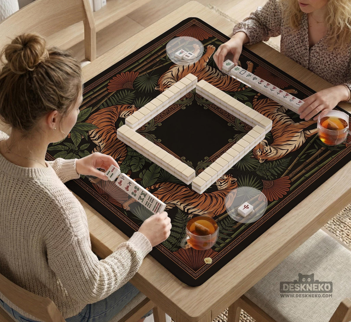 Black square mahjong mat with mirrored tiger faces, bamboo, dark tropical leaves, ornate border details, and orange accents.