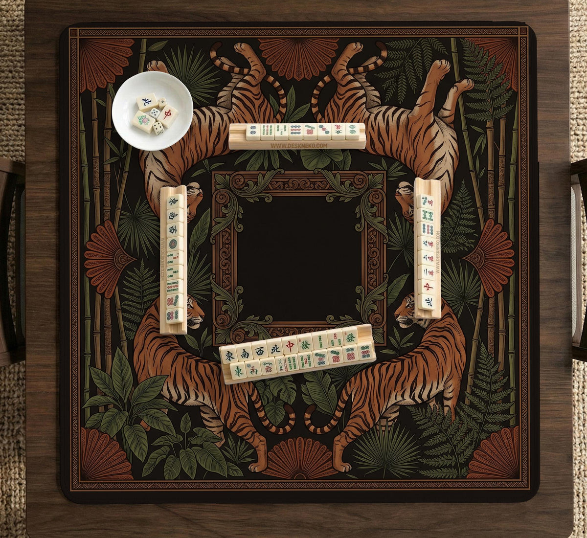 Black square mahjong mat with mirrored tiger faces, bamboo, dark tropical leaves, ornate border details, and orange accents.