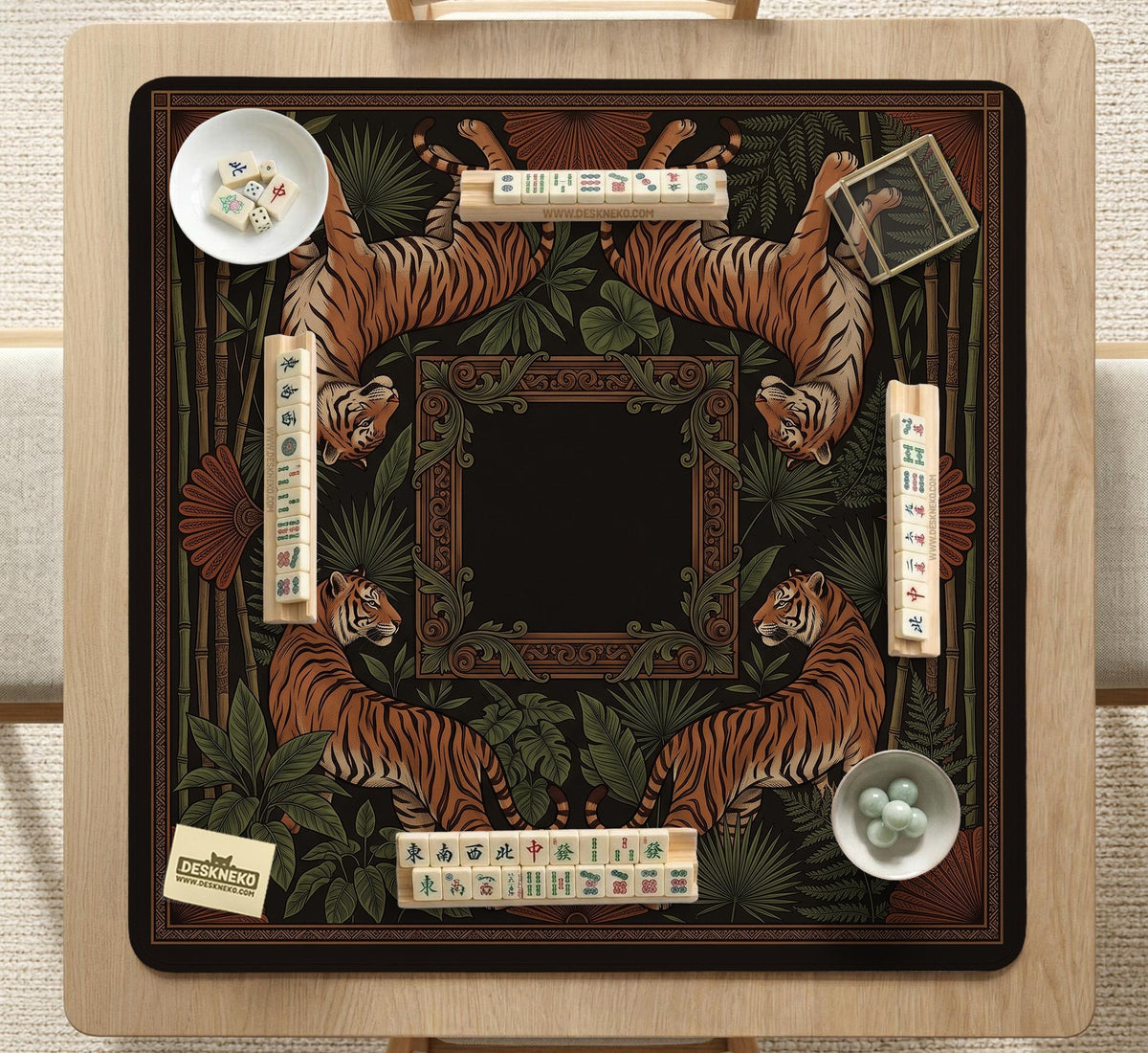 Black square mahjong mat with mirrored tiger faces, bamboo, dark tropical leaves, ornate border details, and orange accents.