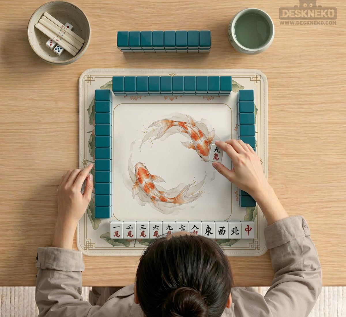 Ivory square mahjong mat with watercolor koi fish, lotus flowers, peach blossoms, sage leaves, and a thin gold border.