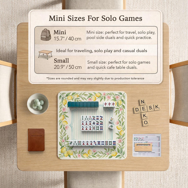 Square yellow mahjong mat with a citrus garden border, green vines, pink blossoms, aqua accents, and a plain center play area.