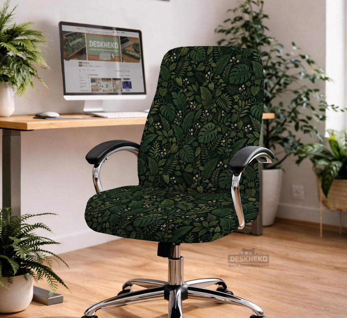 Forest green chair cover with a tropical leaf pattern featuring monstera leaves and small cream flowers.