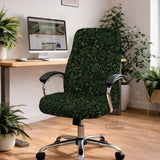 Forest green chair cover with a tropical leaf pattern featuring monstera leaves and small cream flowers.