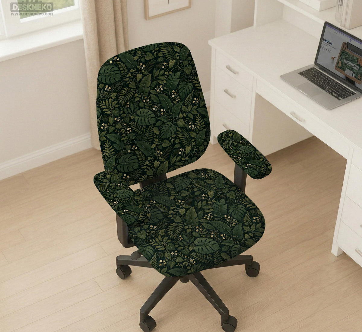 Forest green chair cover with a tropical leaf pattern featuring monstera leaves and small cream flowers.