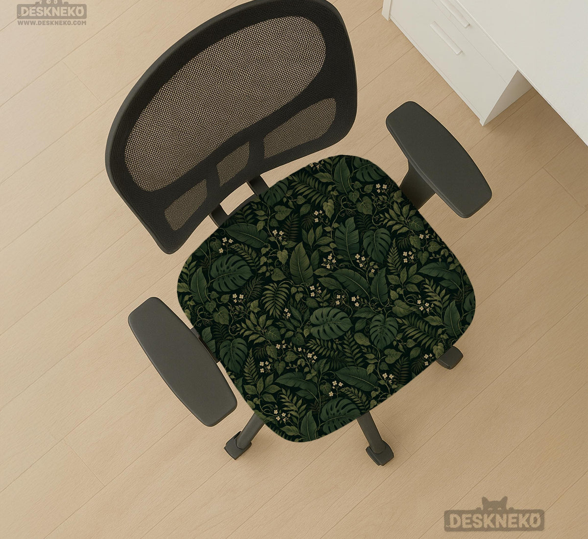 Forest green chair cover with a tropical leaf pattern featuring monstera leaves and small cream flowers.