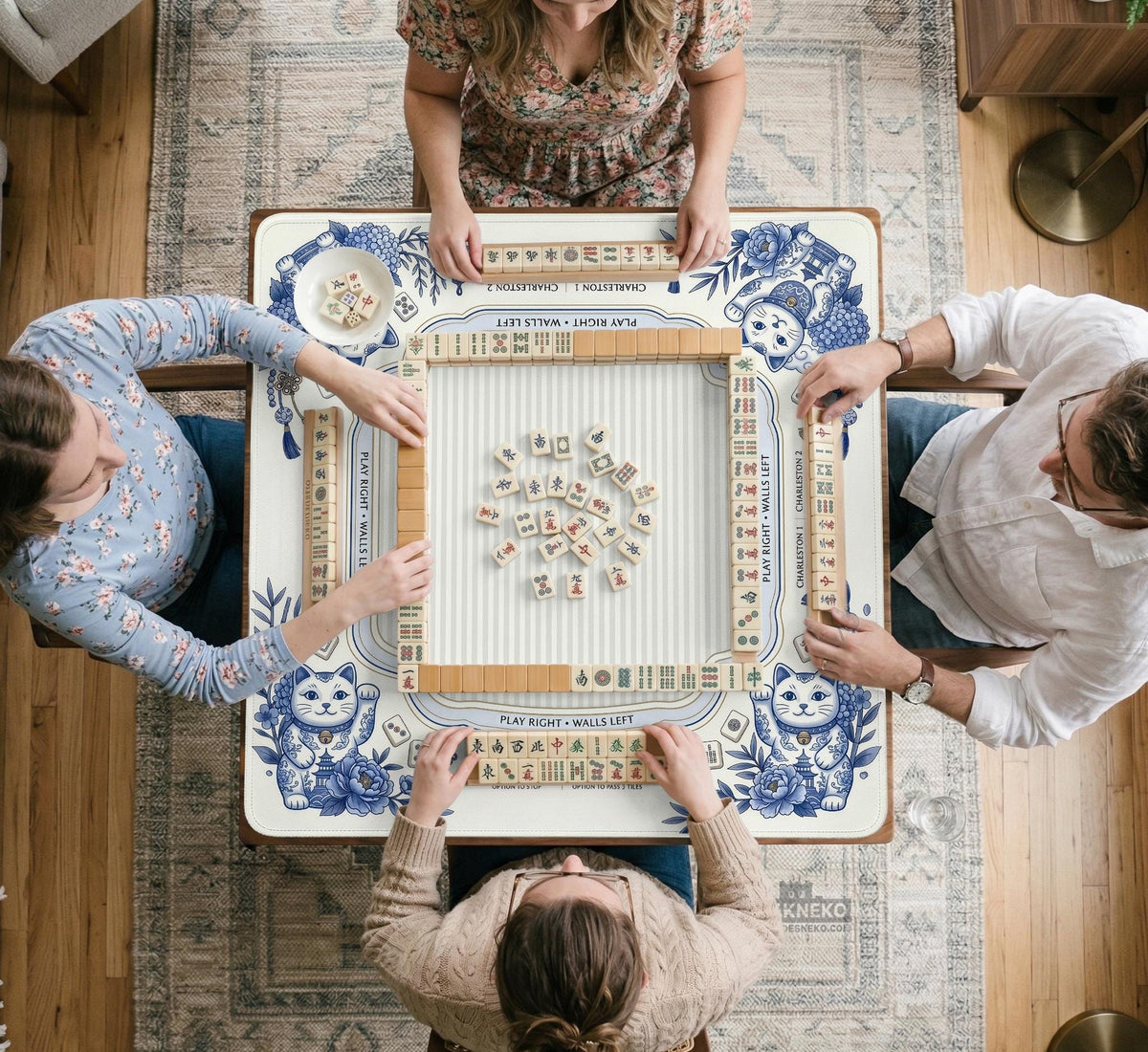 Blue and white square mahjong mat with lucky cat artwork, floral chinoiserie pattern, tile icons, and a rule guide layout.