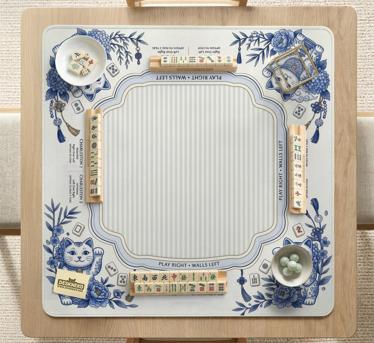 Blue and white square mahjong mat with lucky cat artwork, floral chinoiserie pattern, tile icons, and a rule guide layout.