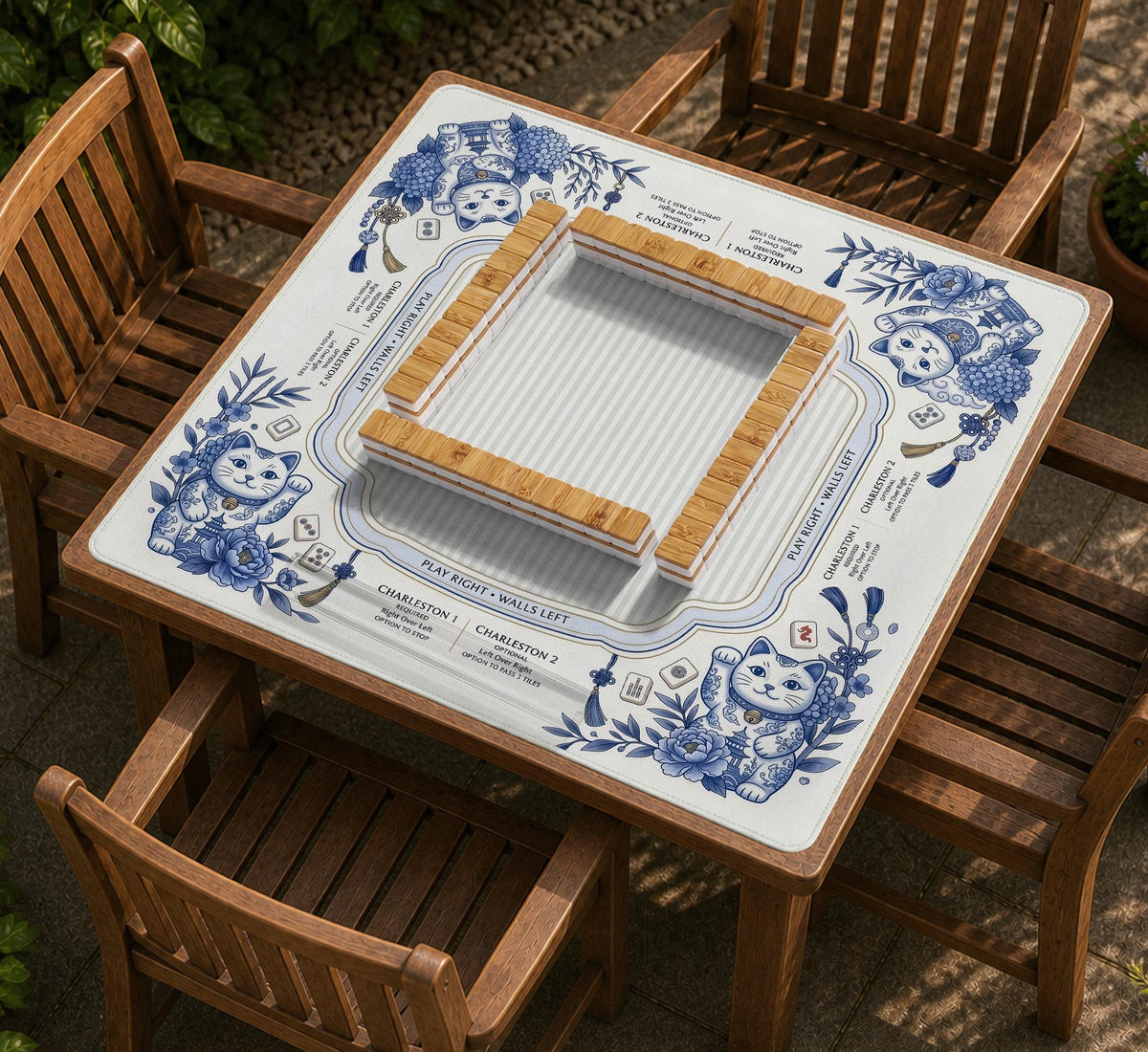 Blue and white square mahjong mat with lucky cat artwork, floral chinoiserie pattern, tile icons, and a rule guide layout.