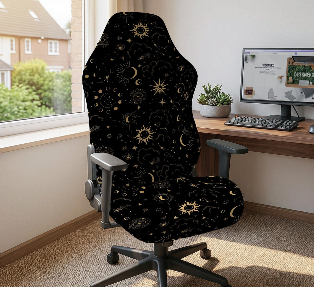 Black chair cover with gold moons, suns, stars, constellations, and line art printed across the fabric.