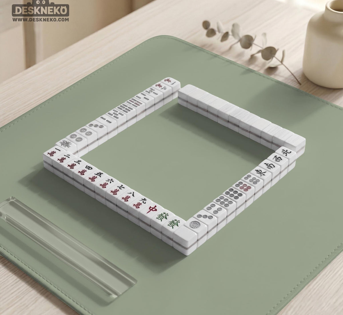 A plain light sage green square mahjong mat with a smooth solid-color surface.