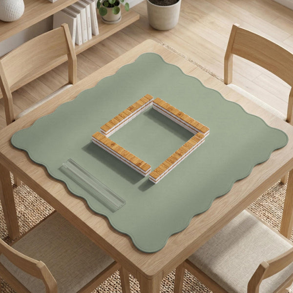 A plain light sage green square mahjong mat with a smooth solid-color surface.