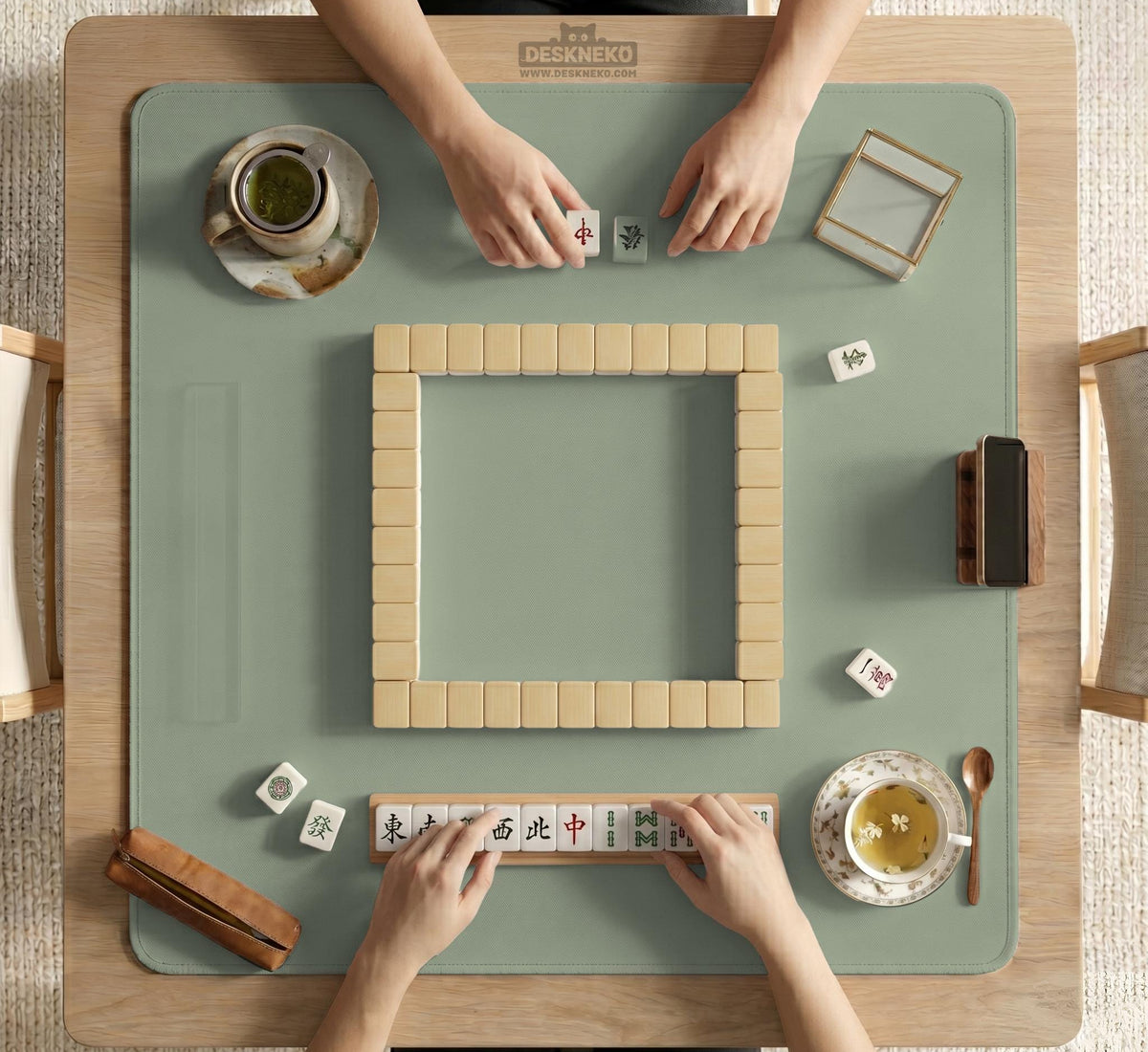 A plain light sage green square mahjong mat with a smooth solid-color surface.