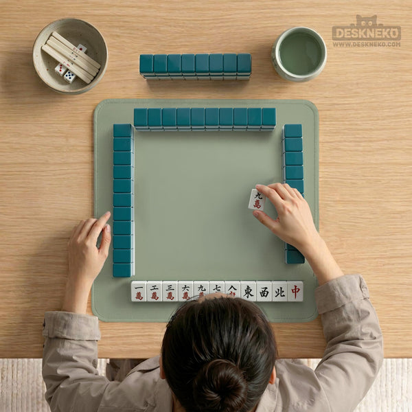 A plain light sage green square mahjong mat with a smooth solid-color surface.