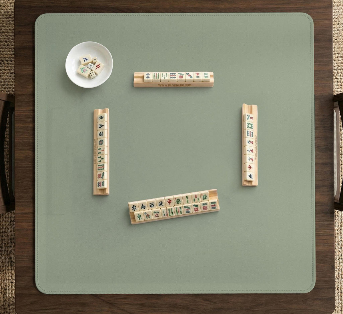 A plain light sage green square mahjong mat with a smooth solid-color surface.