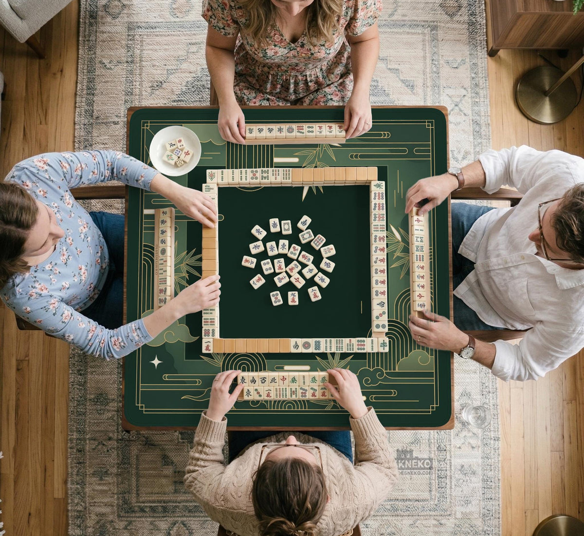Square emerald green mahjong mat with bamboo line art, gold geometric cloud shapes, and a plain center playing area.