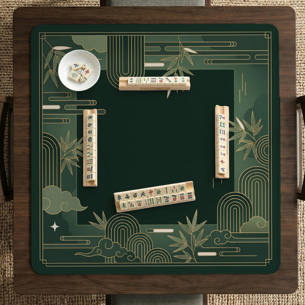 Square emerald green mahjong mat with bamboo line art, gold geometric cloud shapes, and a plain center playing area.