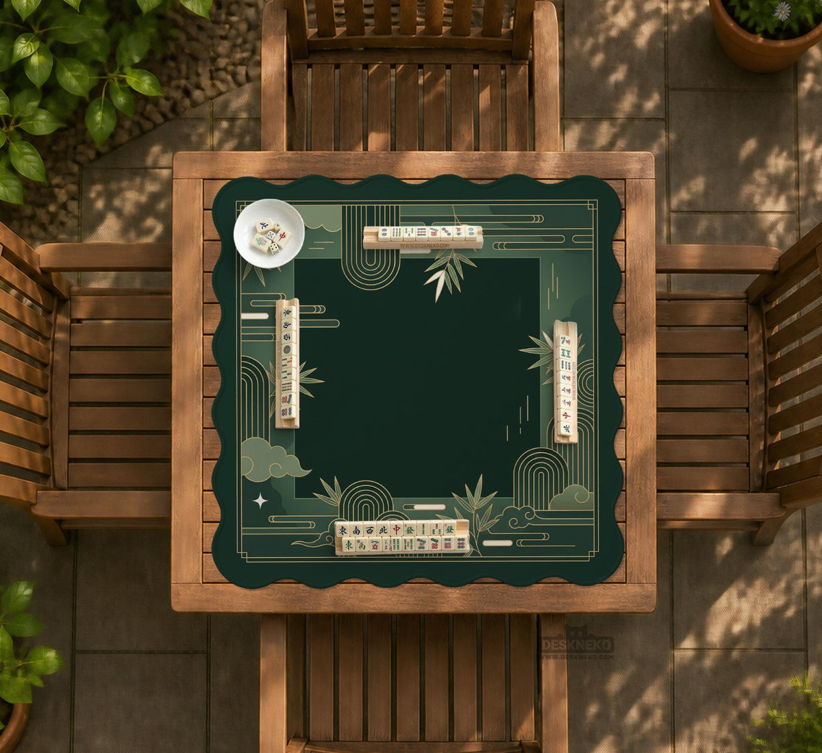 Square emerald green mahjong mat with bamboo line art, gold geometric cloud shapes, and a plain center playing area.