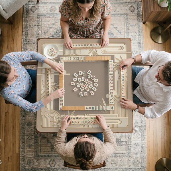 Beige and gold square mahjong mat with a bamboo pattern and geometric border.