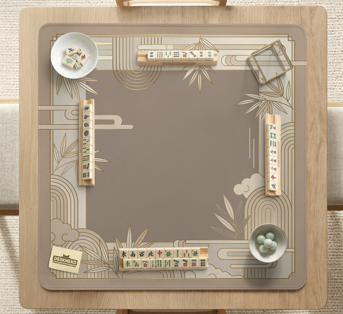 Beige and gold square mahjong mat with a bamboo pattern and geometric border.