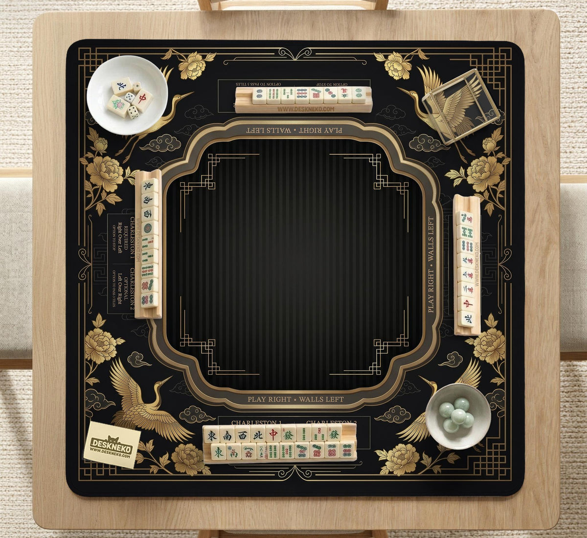 Black and gold square mahjong mat with an art deco crane and floral border, rule reminders around the edges, and a blank center area.