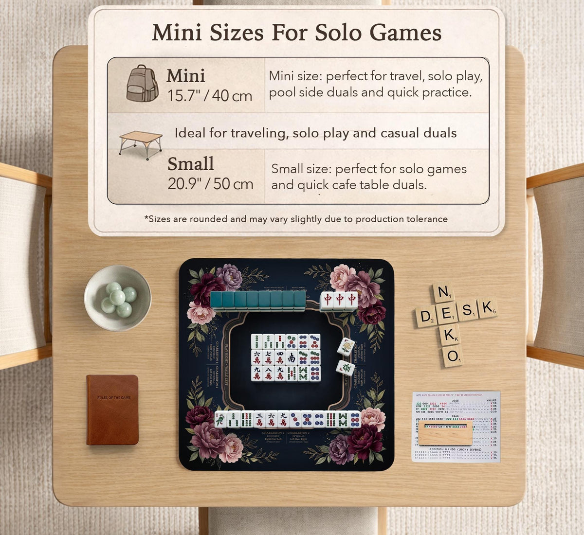 Burgundy mahjong mat with a floral border, gold botanical details, and printed American Mahjong rules on a dark background.