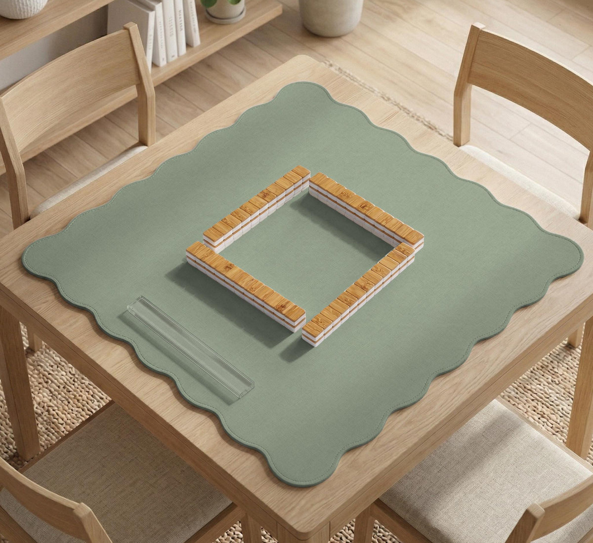 A square sage green mahjong mat with scalloped edges on a plain background.