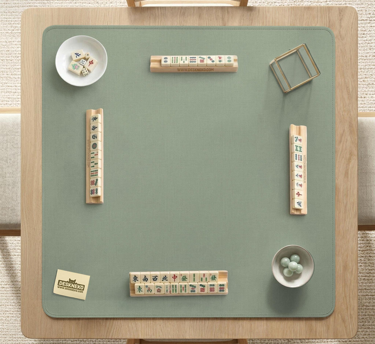 A square sage green mahjong mat with scalloped edges on a plain background.