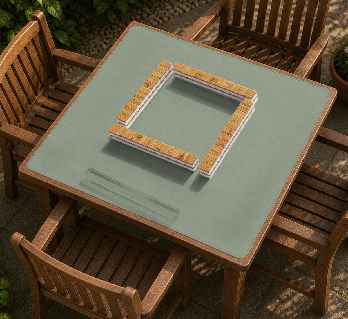 A square sage green mahjong mat with scalloped edges on a plain background.