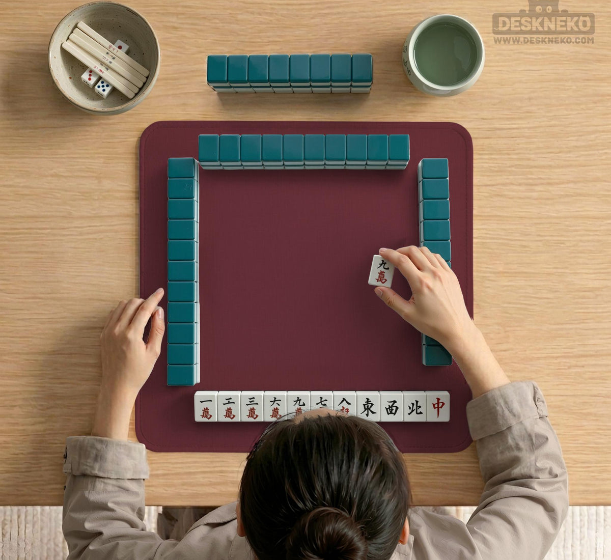 Plain burgundy square mahjong mat with scalloped edges on a white background.