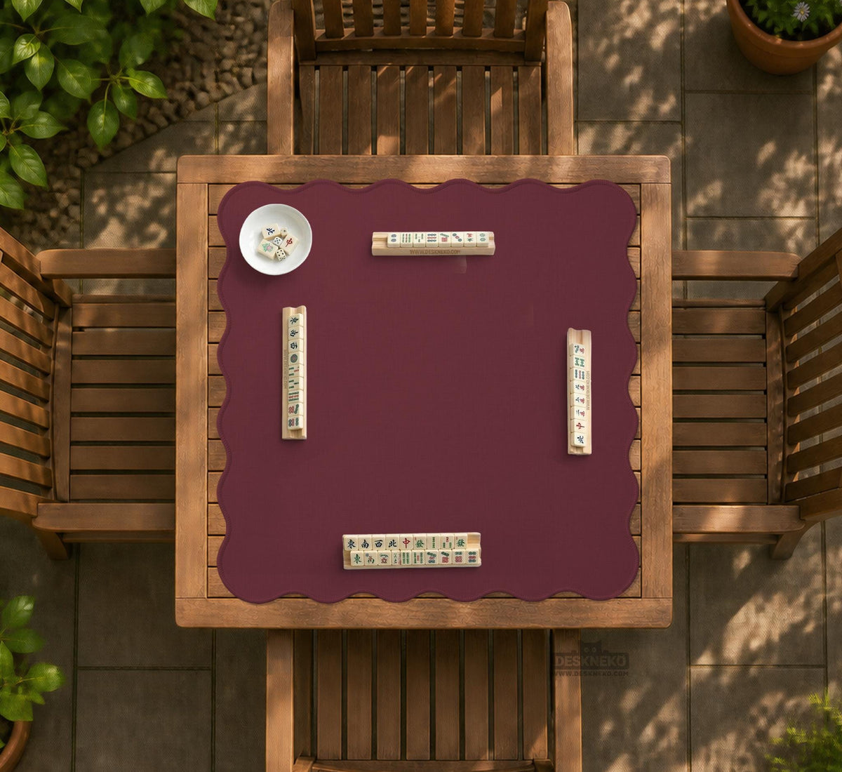 Plain burgundy square mahjong mat with scalloped edges on a white background.