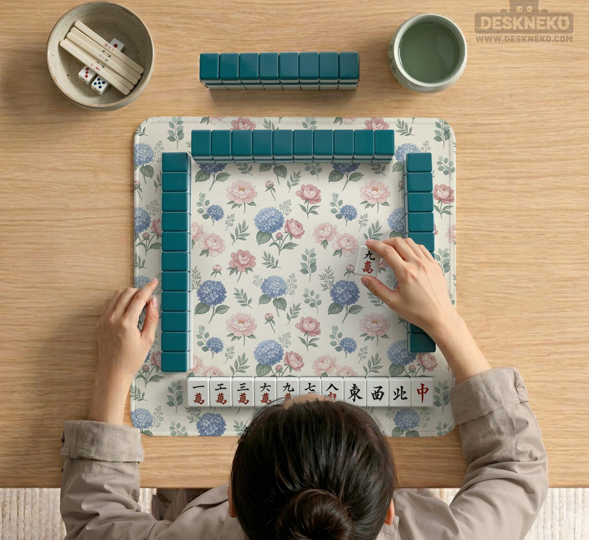Pink floral mahjong table mat with peonies, blue hydrangeas, sage green leaves, and an ivory background.