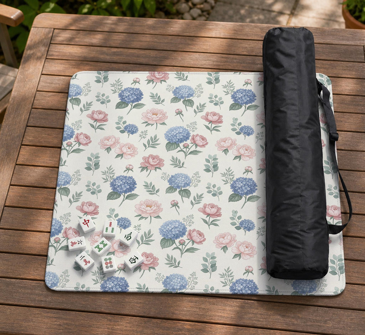 Pink floral mahjong table mat with peonies, blue hydrangeas, sage green leaves, and an ivory background.