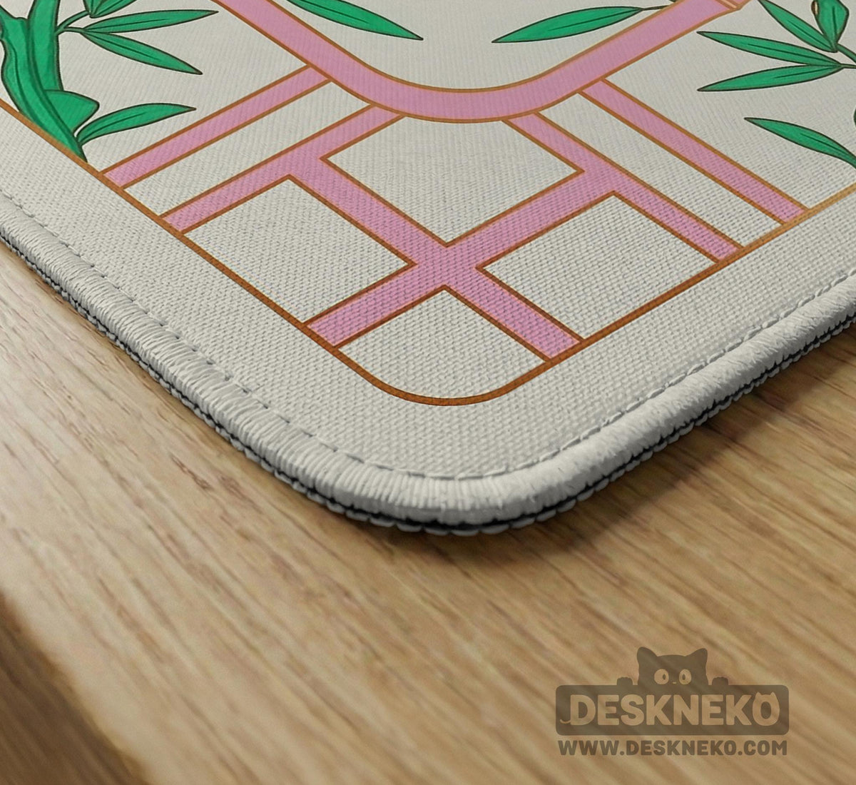 Pink cherry blossom floral mahjong table mat with a cream center and bamboo-style border design.