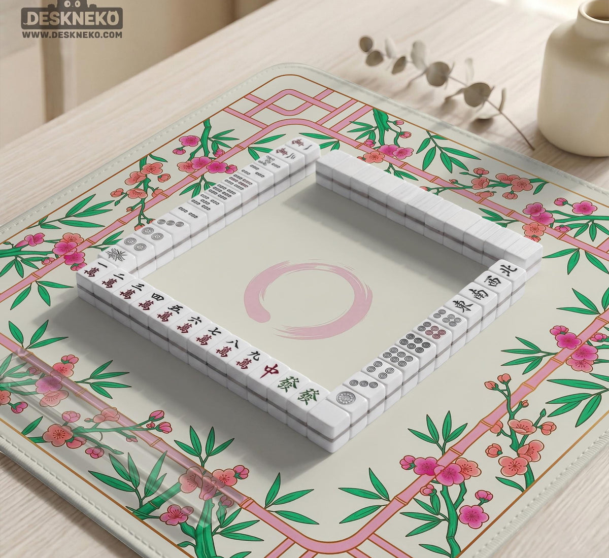 Pink cherry blossom floral mahjong table mat with a cream center and bamboo-style border design.