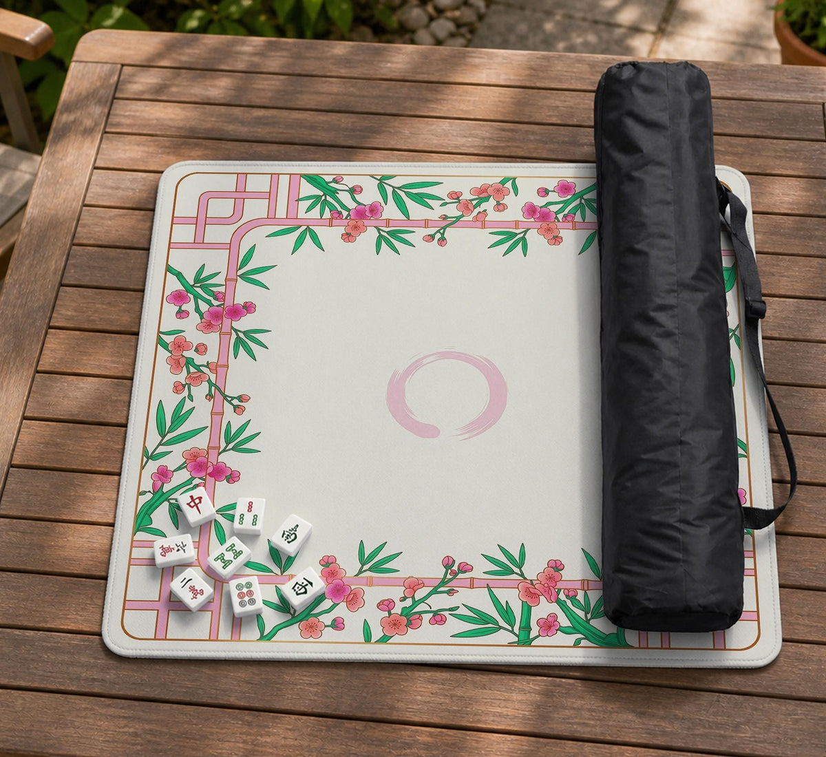 Pink cherry blossom floral mahjong table mat with a cream center and bamboo-style border design.