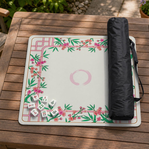 Pink cherry blossom floral mahjong table mat with a cream center and bamboo-style border design.