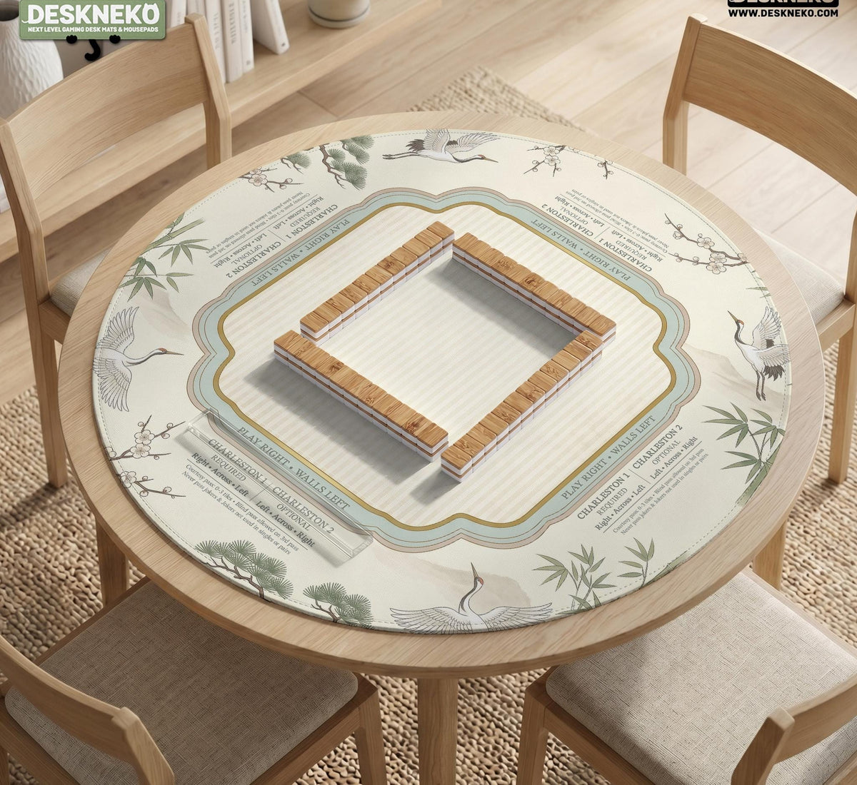 Sage green scalloped mahjong mat with bamboo, crane, and blossom illustration and printed rules around the border.