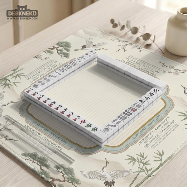 Sage green scalloped mahjong mat with bamboo, crane, and blossom illustration and printed rules around the border.