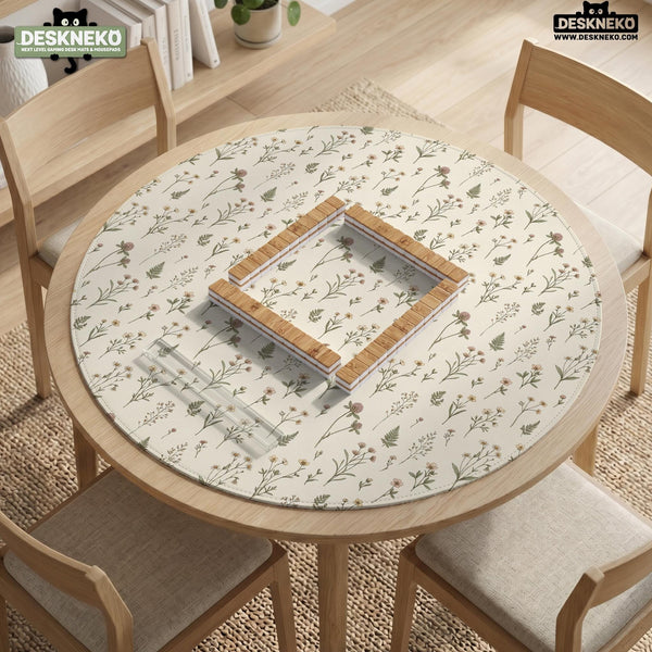 Cream mahjong mat with a floral pattern of small wildflowers and sage leaves, shown with a scalloped edge on a light neutral background.