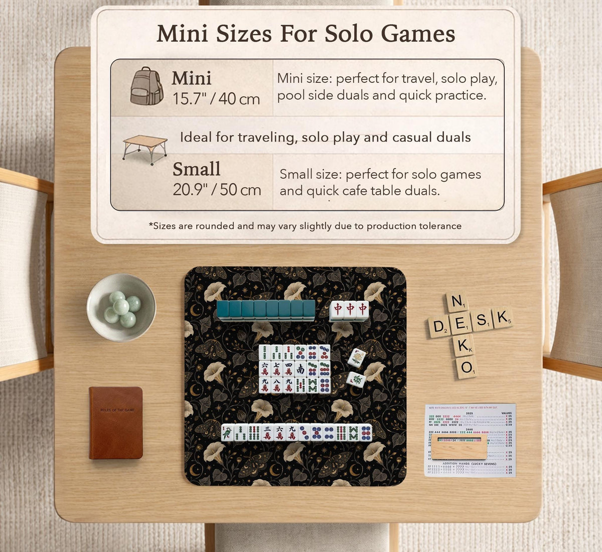Black square mahjong mat with moths, moonflowers, crescent moons, and scattered stars in a celestial floral pattern.